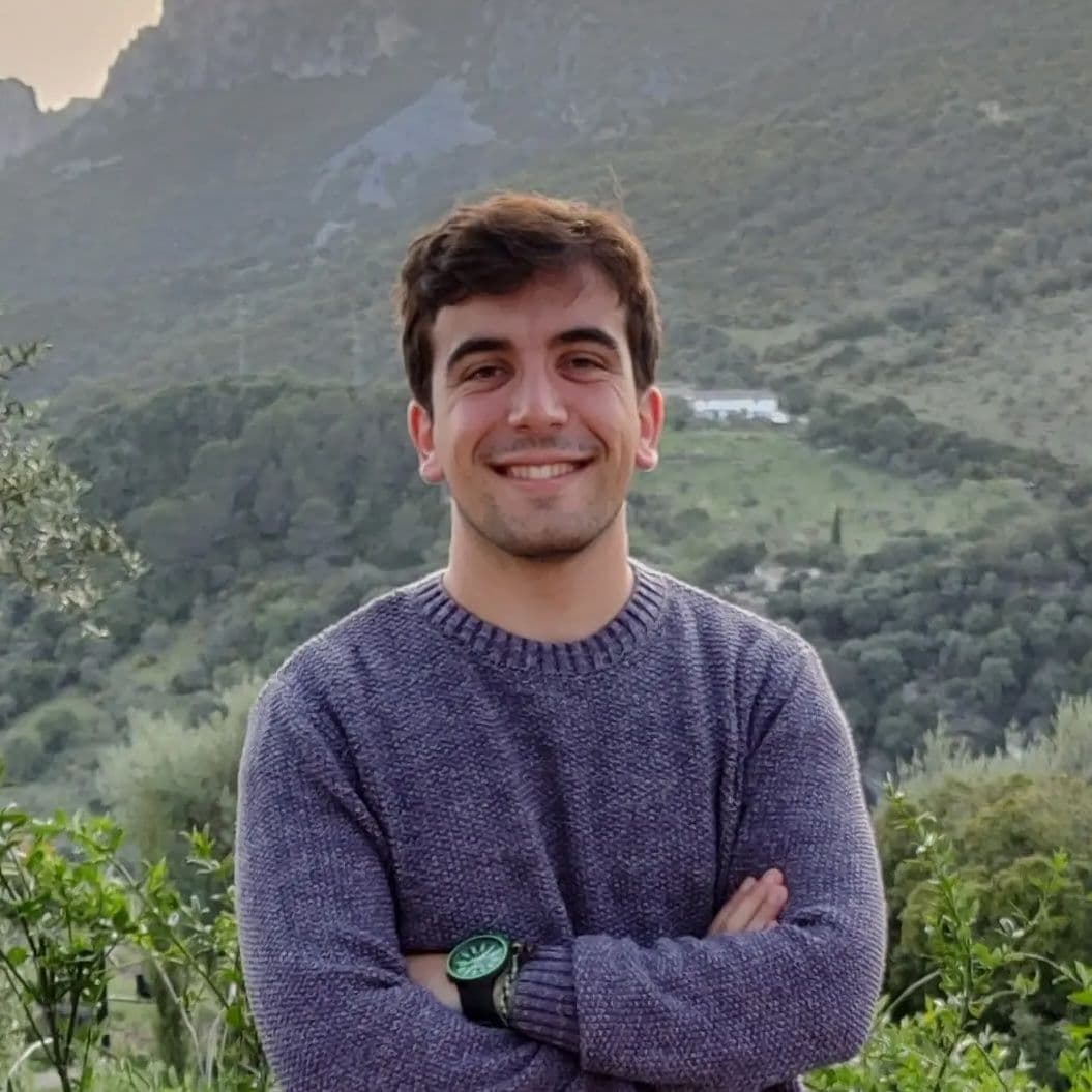 Miguel Ángel standing in front of mountains during sunset